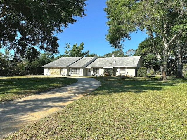 3328 Wax Berry Ct, Windermere, FL 34786 - view of front of property featuring a front lawn, driveway, and a chimney