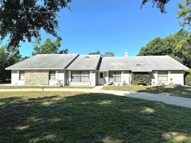 3328 Wax Berry Ct, Windermere, FL 34786 - ranch-style home with stucco siding, a chimney, and a front lawn