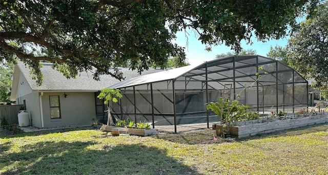 3328 Wax Berry Ct, Windermere, FL 34786 - rear view of house with a shingled roof, a yard, a garden, and stucco siding