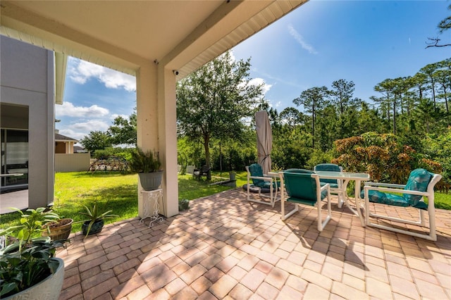 view of patio with fence and outdoor dining area