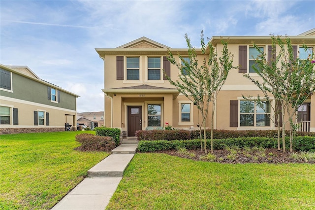 view of front facade featuring a front lawn and stucco siding
