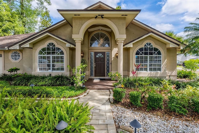 entrance to property with stucco siding