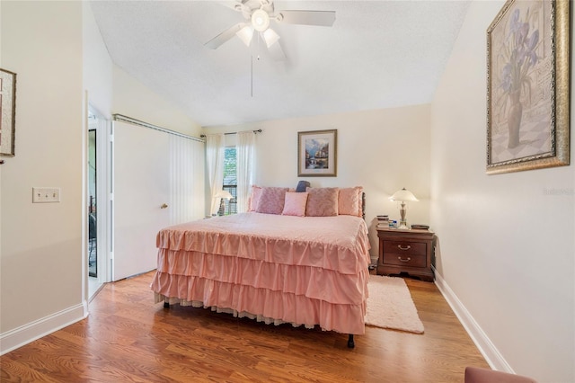98 Lakepointe Cir, Kissimmee, FL 34743 - bedroom with lofted ceiling, a closet, wood finished floors, and baseboards