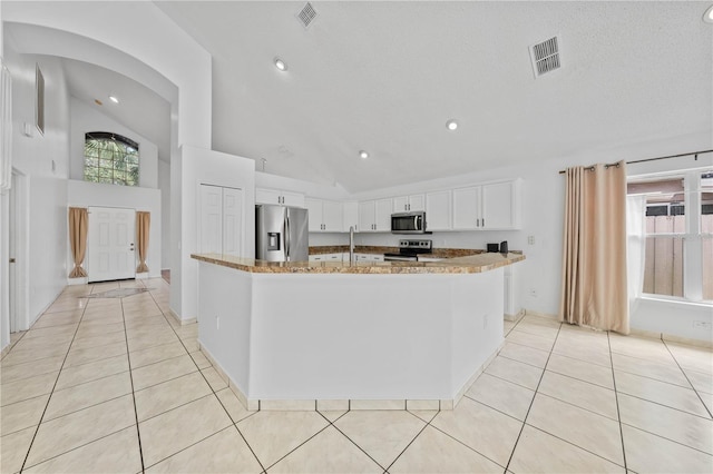 kitchen featuring light tile patterned floors, appliances with stainless steel finishes, and visible vents