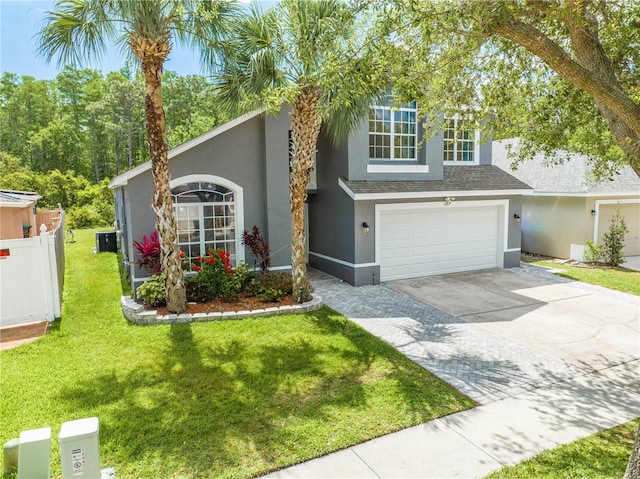 view of front facade featuring fence, a garage, stucco siding, a front yard, and driveway