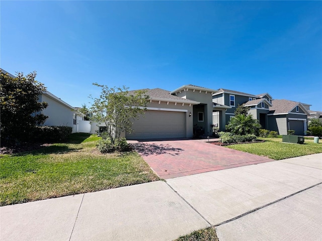 1321 Yorkdale Rd, Davenport, FL 33837 - prairie-style home featuring decorative driveway, a garage, a front yard, and stucco siding