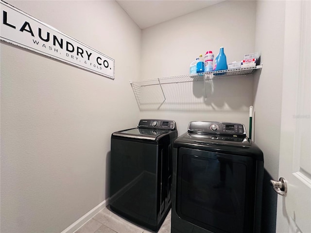 1321 Yorkdale Rd, Davenport, FL 33837 - laundry area featuring baseboards, laundry area, light tile patterned flooring, and washing machine and clothes dryer