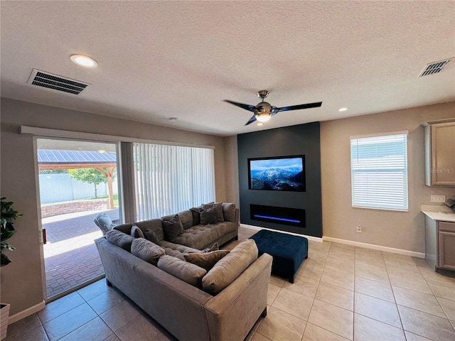 1321 Yorkdale Rd, Davenport, FL 33837 - living area with light tile patterned floors, baseboards, a textured ceiling, and visible vents