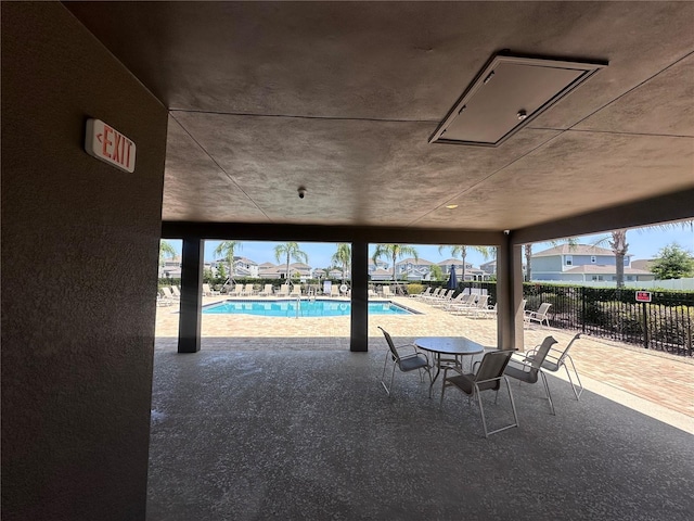 1321 Yorkdale Rd, Davenport, FL 33837 - view of patio / terrace featuring a community pool and fence