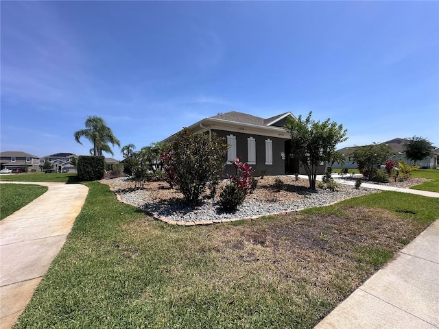 1321 Yorkdale Rd, Davenport, FL 33837 - view of side of property featuring stucco siding and a yard