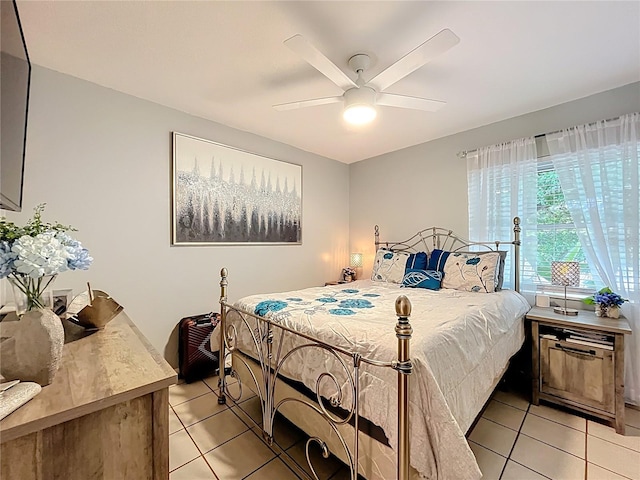 bedroom with ceiling fan and light tile patterned flooring