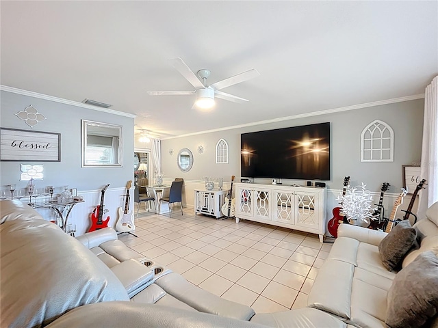 living room featuring crown molding, a ceiling fan, visible vents, and light tile patterned floors