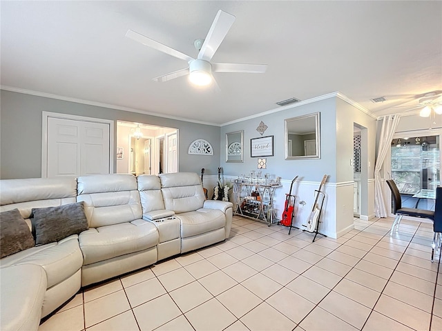 living area featuring light tile patterned floors, crown molding, ceiling fan, and visible vents