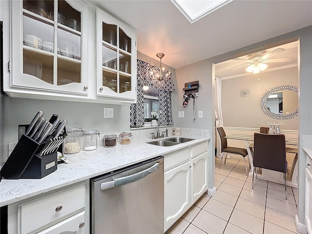 kitchen with light tile patterned flooring, a sink, white cabinetry, stainless steel dishwasher, and glass insert cabinets