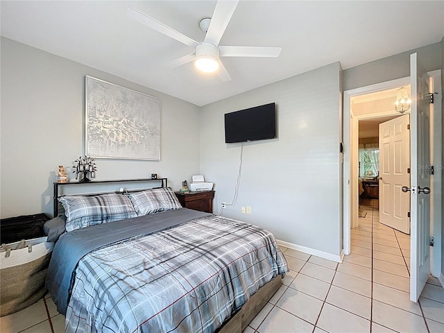 bedroom with light tile patterned floors and ceiling fan with notable chandelier