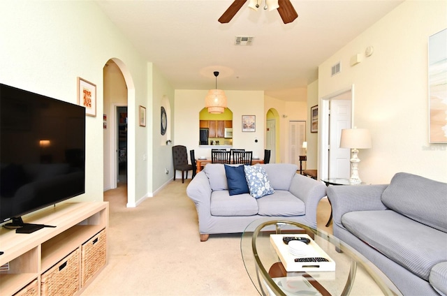 2778 Almaton Loop Unit 403, Kissimmee, FL 34747 - living area featuring visible vents, arched walkways, ceiling fan, and light colored carpet
