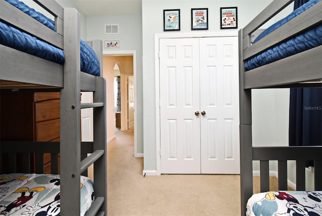 2778 Almaton Loop Unit 403, Kissimmee, FL 34747 - carpeted bedroom with a closet, arched walkways, baseboards, and visible vents