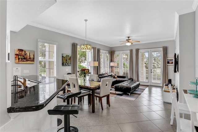 1501 Northern Harrier Way Unit 101, Kissimmee, FL 34747 - dining area featuring crown molding, a ceiling fan, and light tile patterned floors