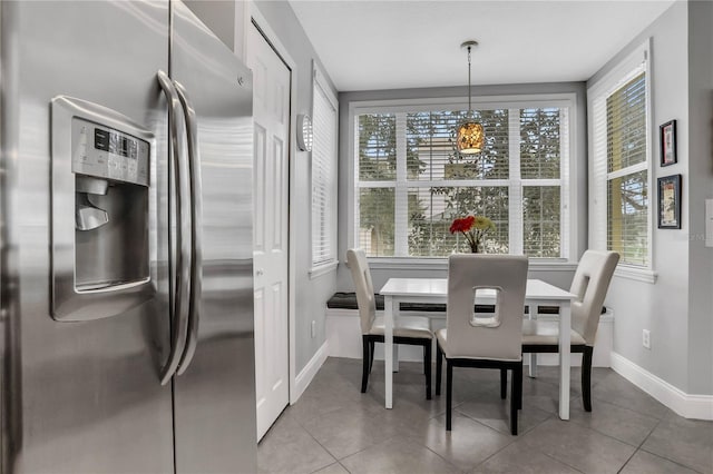 1501 Northern Harrier Way Unit 101, Kissimmee, FL 34747 - dining space featuring baseboards, plenty of natural light, and tile patterned floors