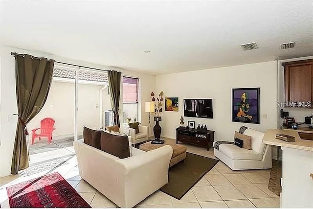 living room with visible vents and light tile patterned flooring