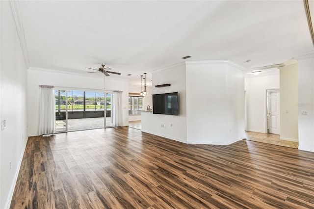 759 Glendora Rd, Kissimmee, FL 34759 - unfurnished living room featuring ceiling fan, crown molding, dark wood-style floors, and baseboards