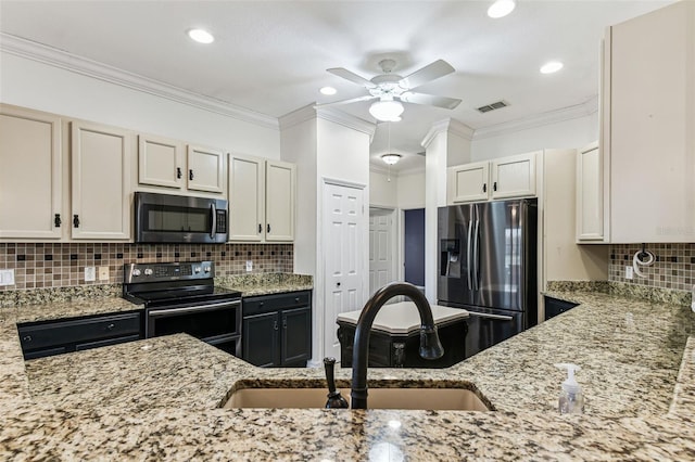 759 Glendora Rd, Kissimmee, FL 34759 - kitchen featuring stainless steel appliances, a sink, light stone countertops, ceiling fan, and ornamental molding