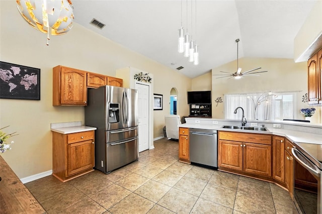 kitchen with visible vents, a ceiling fan, lofted ceiling, a sink, and stainless steel appliances