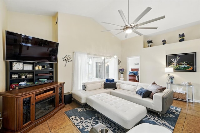 tiled living room with a ceiling fan and high vaulted ceiling