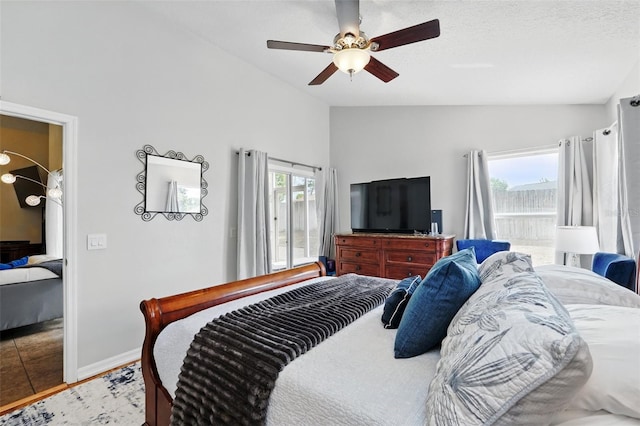 bedroom featuring baseboards, a ceiling fan, and vaulted ceiling