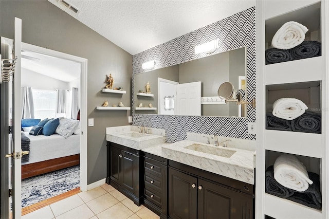 full bathroom featuring a sink, ensuite bathroom, vaulted ceiling, and double vanity