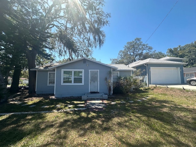 8702 El Portal Dr, Tampa, FL 33604 - single story home featuring a front lawn, an attached garage, and concrete driveway