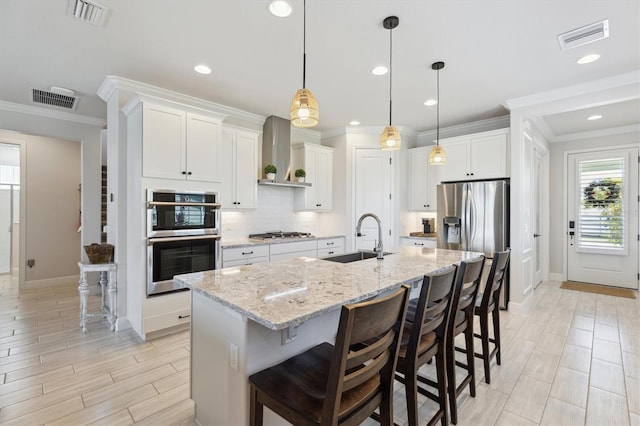 2476 Kamin Dr, Melbourne, FL 32940 - kitchen with a sink, appliances with stainless steel finishes, wall chimney range hood, and visible vents