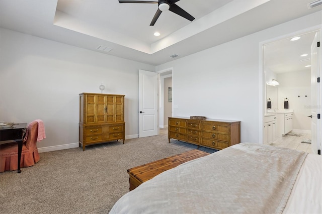 2476 Kamin Dr, Melbourne, FL 32940 - bedroom featuring connected bathroom, a raised ceiling, recessed lighting, baseboards, and visible vents