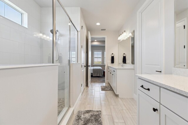 2476 Kamin Dr, Melbourne, FL 32940 - ensuite bathroom featuring connected bathroom, recessed lighting, a shower stall, and vanity