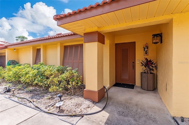 5053 Maui Cir Unit 14, Orlando, FL 32808 - property entrance featuring stucco siding and a tiled roof