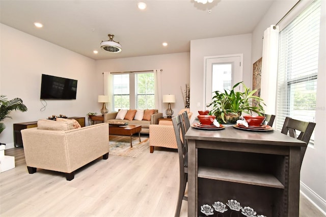 living area featuring recessed lighting and light wood finished floors