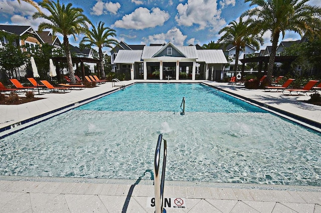 pool with fence and a patio area