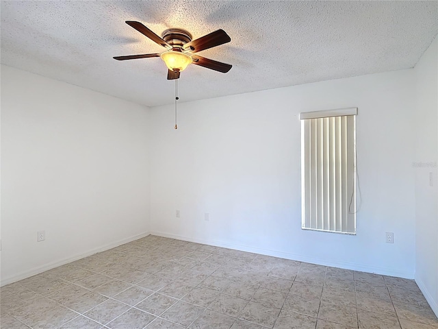 unfurnished room with baseboards, a textured ceiling, ceiling fan, and light tile patterned floors