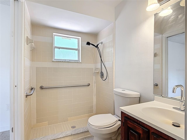 full bath with toilet, a tile shower, and vanity