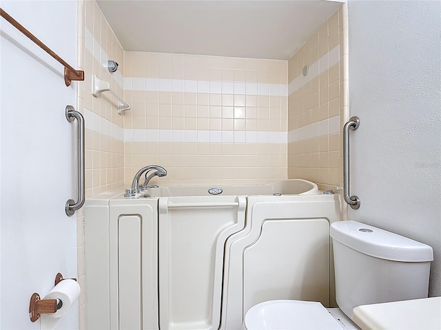 bathroom featuring a bath and toilet