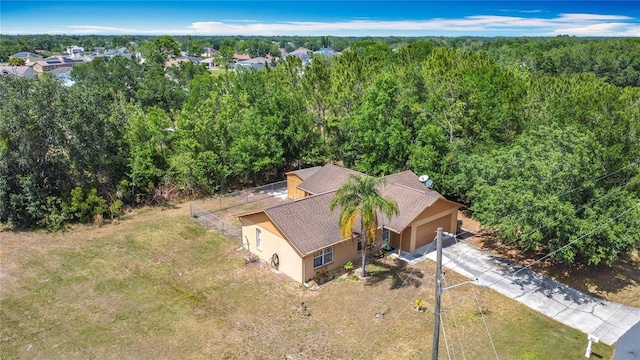 birds eye view of property with a view of trees
