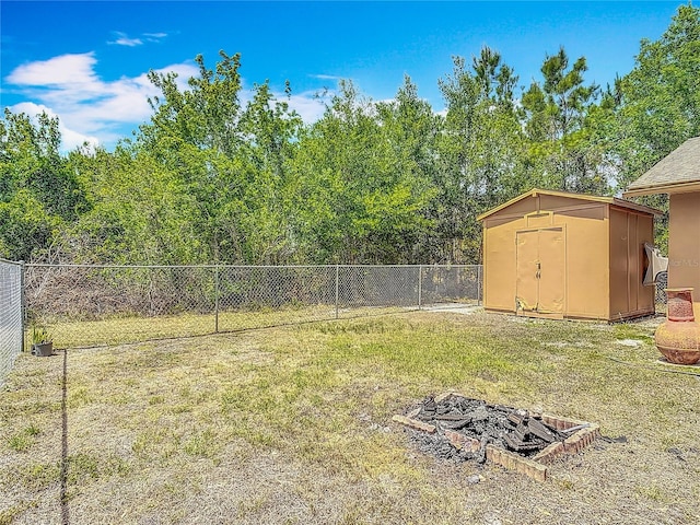 view of yard with a fenced backyard, an outdoor structure, and a shed