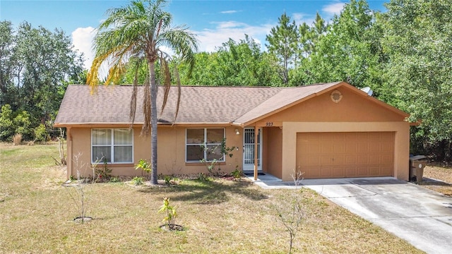 ranch-style home with an attached garage, driveway, a front lawn, and stucco siding