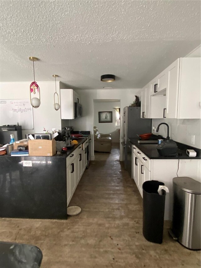 225 Ronnie Cir, Orlando, FL 32811 - kitchen with a sink, stainless steel appliances, white cabinetry, and dark countertops