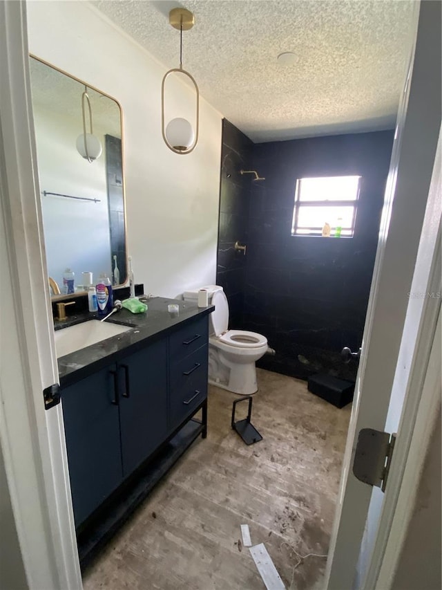 225 Ronnie Cir, Orlando, FL 32811 - full bathroom featuring vanity, toilet, a stall shower, and a textured ceiling