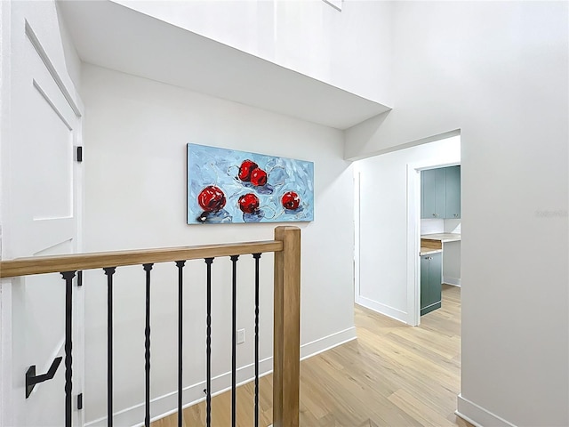 hall with baseboards and light wood-style flooring