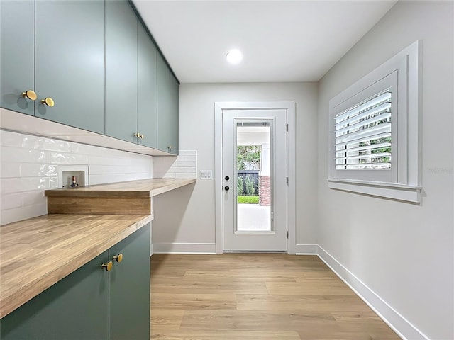 doorway to outside featuring light wood-style floors, recessed lighting, and baseboards
