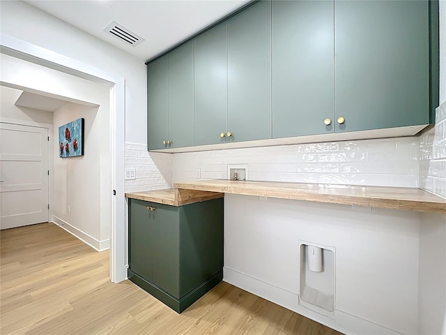 interior space with visible vents, light wood-style floors, baseboards, and tasteful backsplash