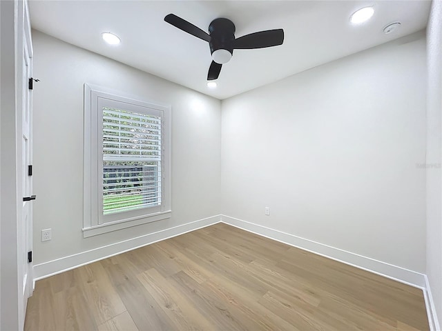 spare room with recessed lighting, baseboards, and light wood-type flooring