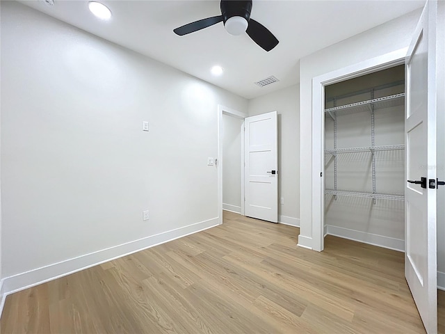 unfurnished bedroom featuring light wood-style floors, recessed lighting, baseboards, visible vents, and a closet